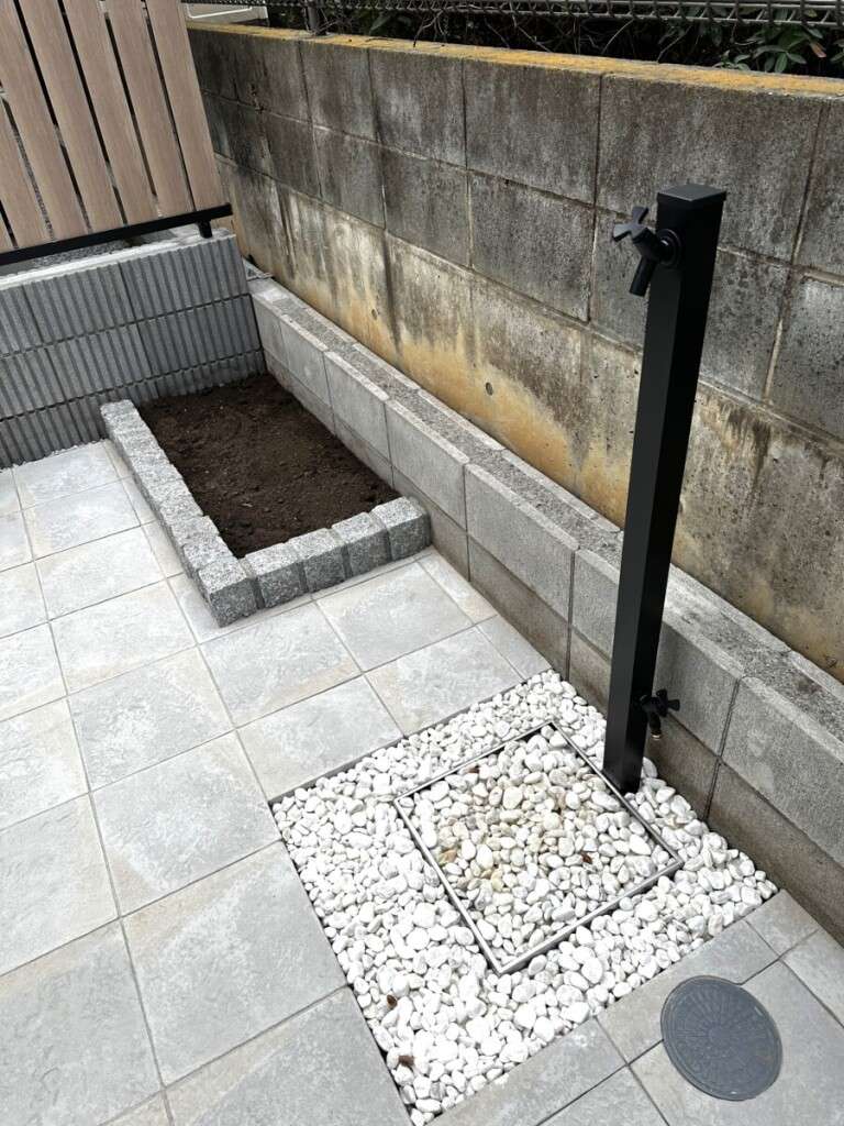 お庭の空間を引き締める、ブラック色のスタイリッシュな立水栓と植栽の緑。